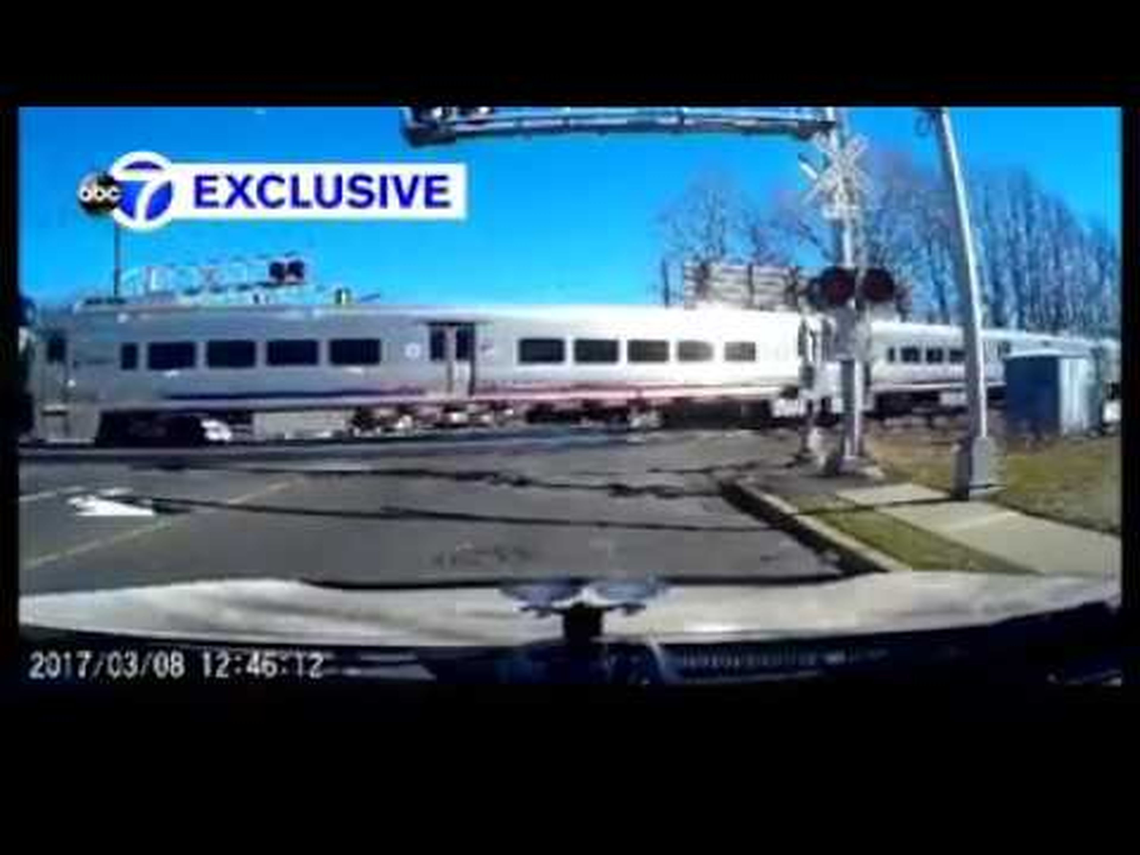 HERO! Driver leaps from car to save elderly woman crossing in front of train