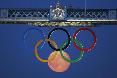 In a photo worthy of a gold medal, the full moon rose through the Olympic Rings hanging beneath Tower Bridge during the London 2012 Olympics. In a photo worthy of a gold medal, the full moon rose through the Olympic Rings hanging beneath Tower Bridge during the London 2012 Olympics.