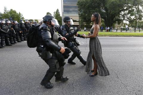 "A woman standing calmly, her long dress moving in the breeze, two police officers in full riot gear make their move," Reuters photographer Jonathan Bachman said of capturing this snapshot from a demonstration in Baton Rouge. "A woman standing calmly, her long dress moving in the breeze, two police officers in full riot gear make their move," Reuters photographer Jonathan Bachman said of capturing this snapshot from a demonstration in Baton Rouge.